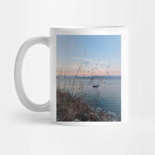 Serene Ocean Sunset: Boat Amidst Weeds Mug